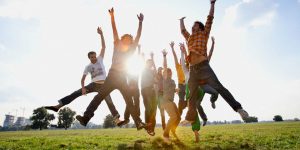 Group of friends jumping --- Image by © Daniel Koebe/Corbis