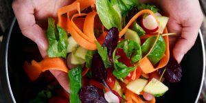 Fresh Close up Vegetable Vegan salad in man hand. healthy food.
